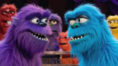 Group Of Colorful Furry Monsters In A Classroom Setting