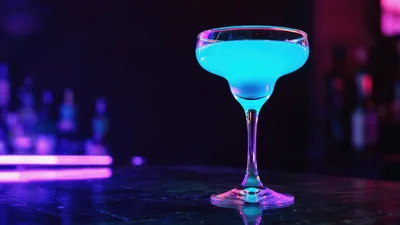 Bright Blue Cocktail Glass on a Neon Lit Bar