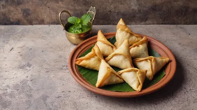 Crispy Fried Samosas Served On A Clay Plate