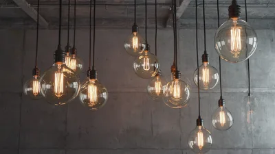 Vintage Edison Light Bulbs Hanging Against Concrete Wall