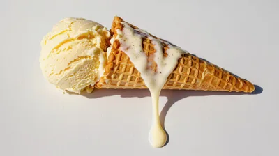Melting Vanilla Ice Cream Scoop In Waffle Cone