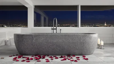 Modern Stone Bathtub With Rose Petals In Luxury Bathroom