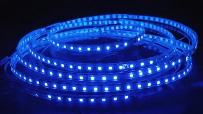 Coiled Blue LED Light Strip Glowing In Darkness