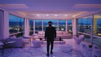 Man Wearing Face Mask Standing In Modern Luxury Penthouse