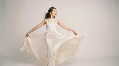 Elegant Woman In Silk Dress Posing In Studio