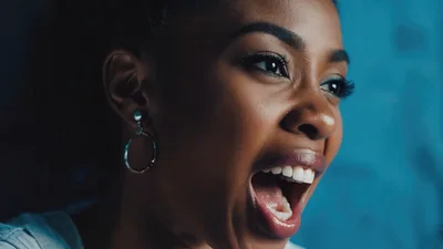 Close Up Portrait Of A Joyful Young Woman Laughing