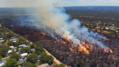 Aerial View Of Forest Fire Near Residential Neighborhood