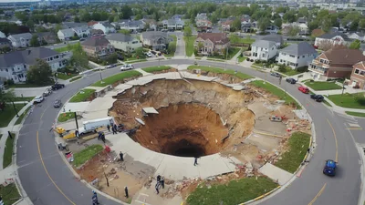 Massive Sinkhole Opening In A Suburban Residential Neighborhood