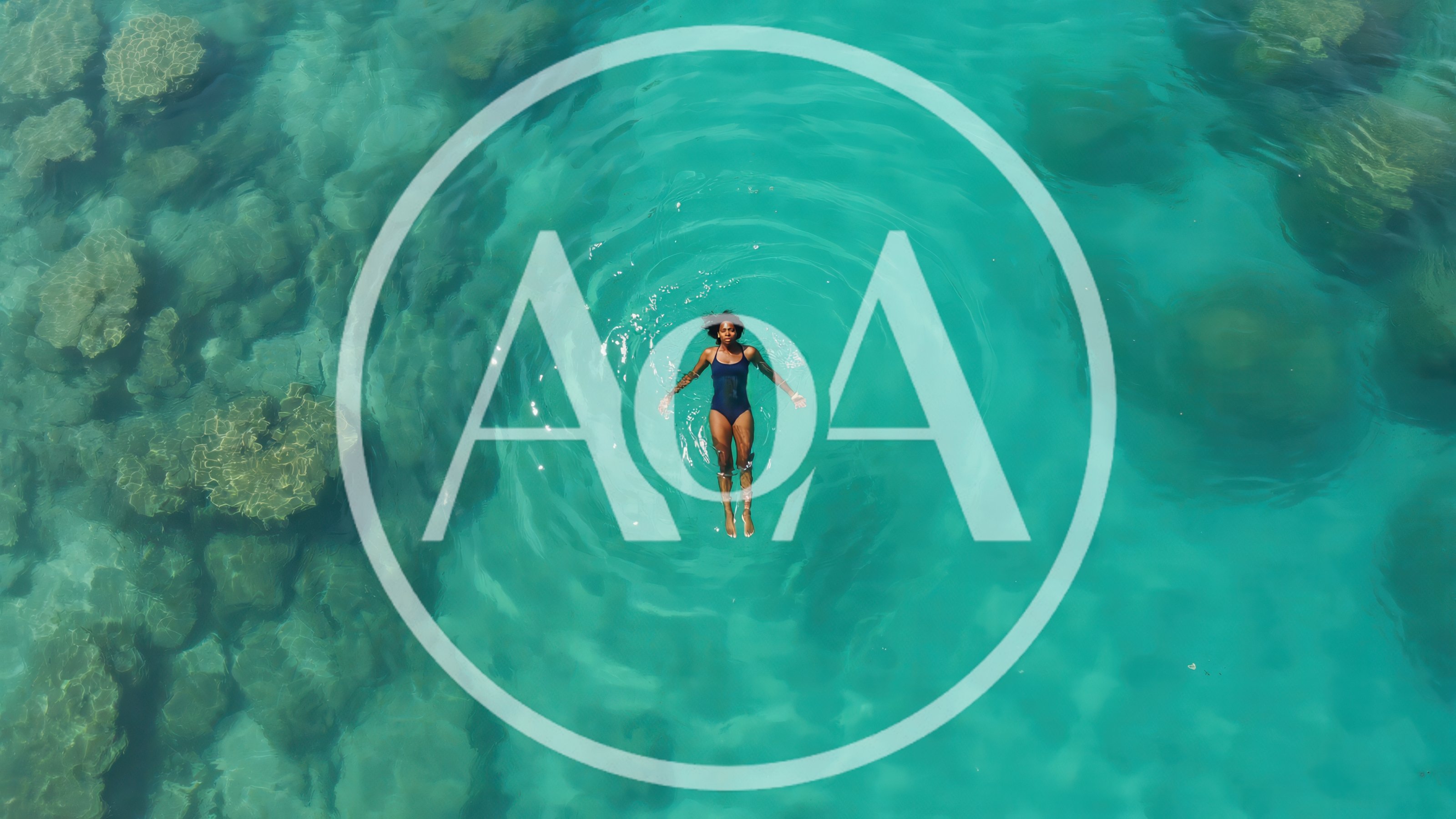 Woman Floating In Clear Tropical Ocean Water