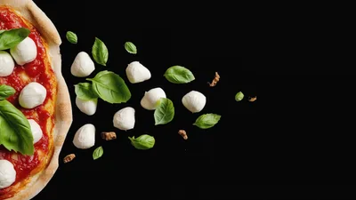 Fresh Pizza Ingredients Floating Against Black Background