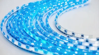 Coiled Blue LED Light Strip on White Background