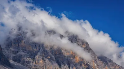 Majestic Dolomite Mountain Peak With Clouds