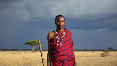 Maasai Warrior Standing In The African Savanna