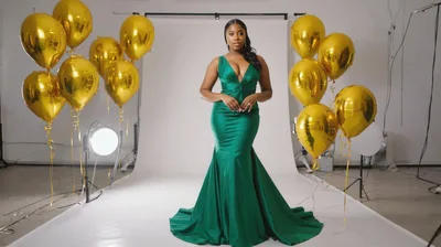 Elegant Woman In Green Evening Gown With Gold Balloons