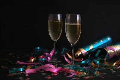 Two Champagne Flutes With Party Decorations