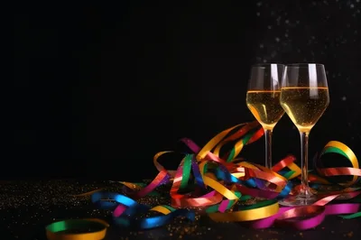 Two Champagne Glasses With Colorful Party Ribbons