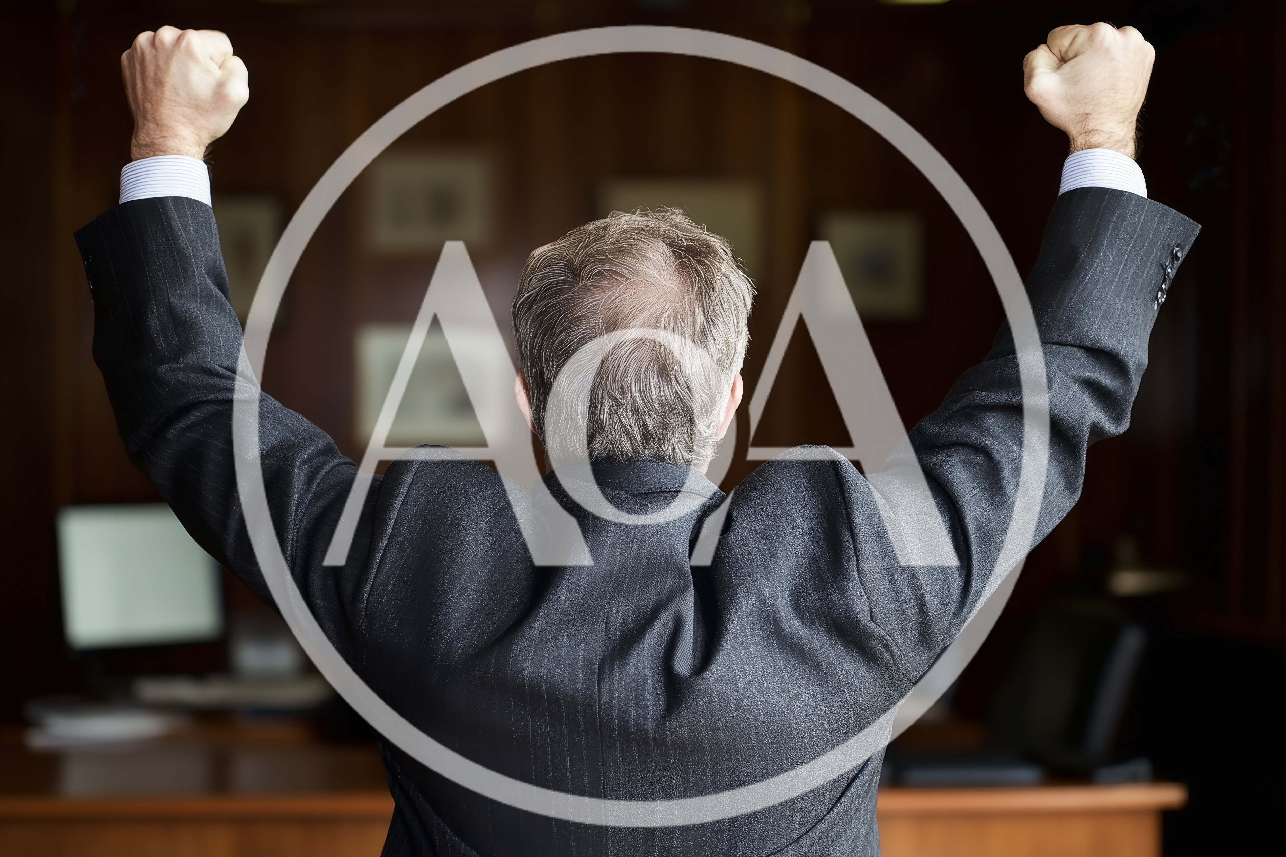 Businessman Celebrating Success With Arms Raised In Office