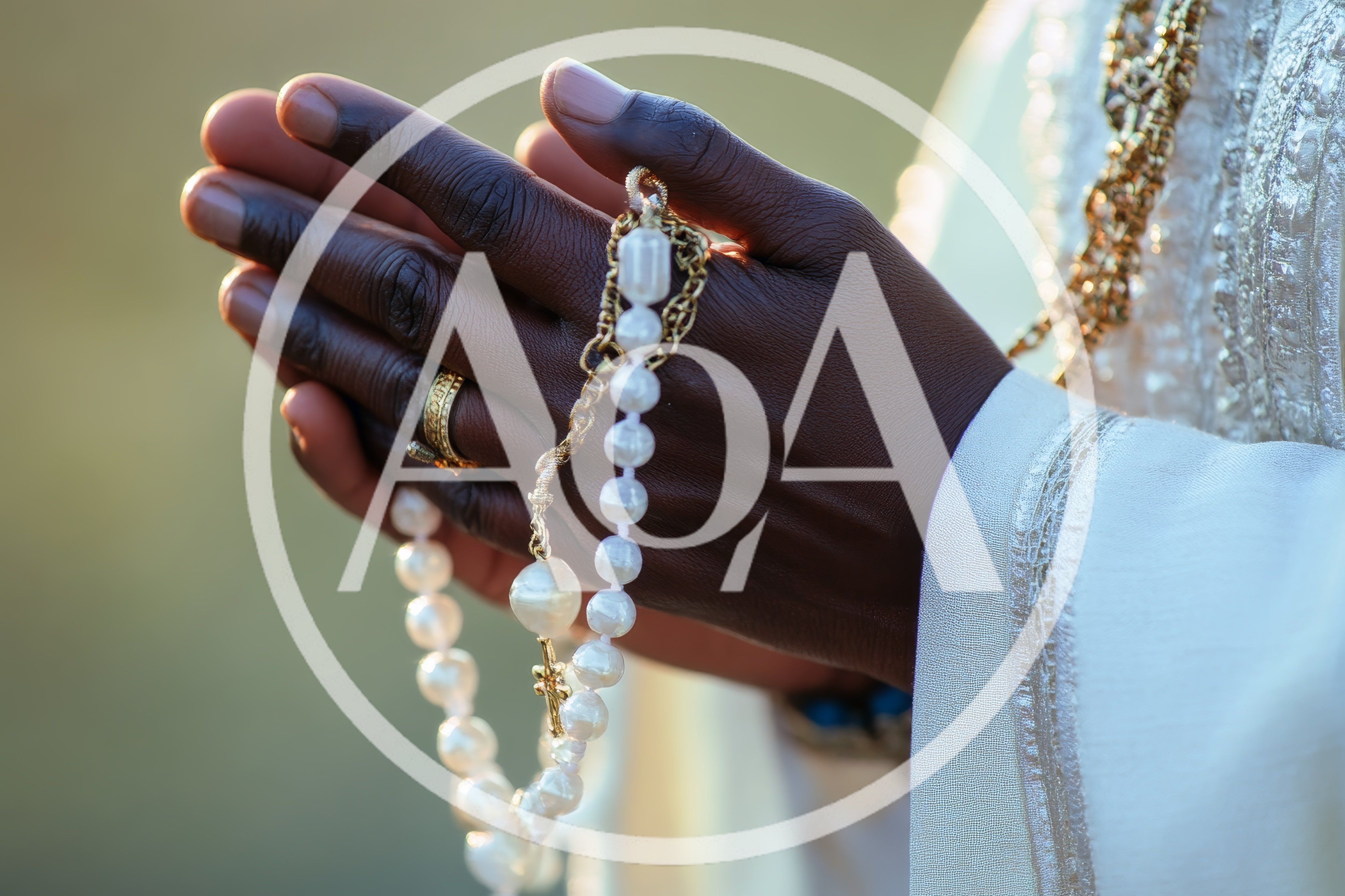 Close Up Of Hands Holding A Pearl Rosary