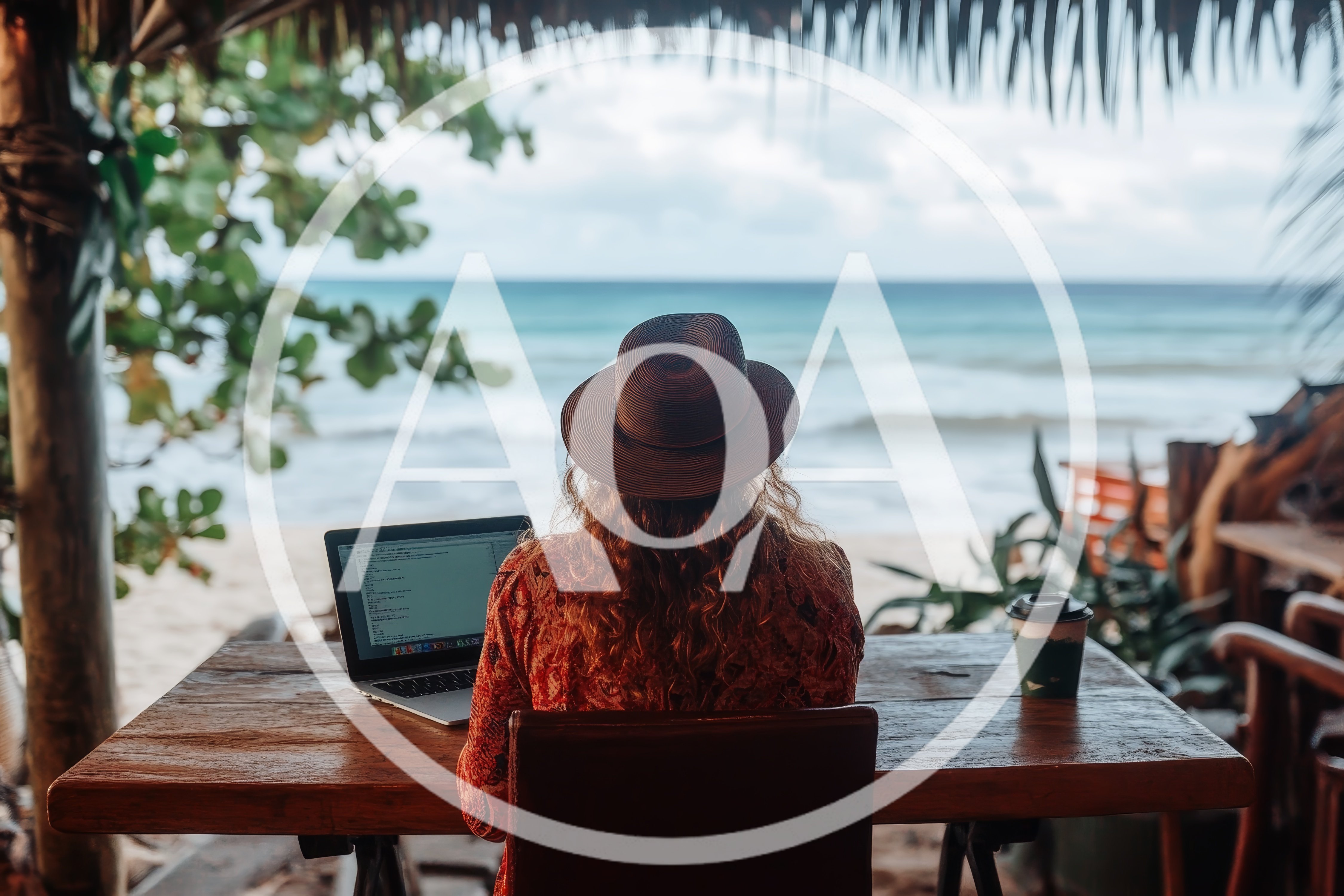 Woman Working On Laptop At Beachside Cafe