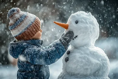Young Child Building A Snowman In Winter