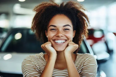 Happy Young Woman Smiling In A Car Dealership