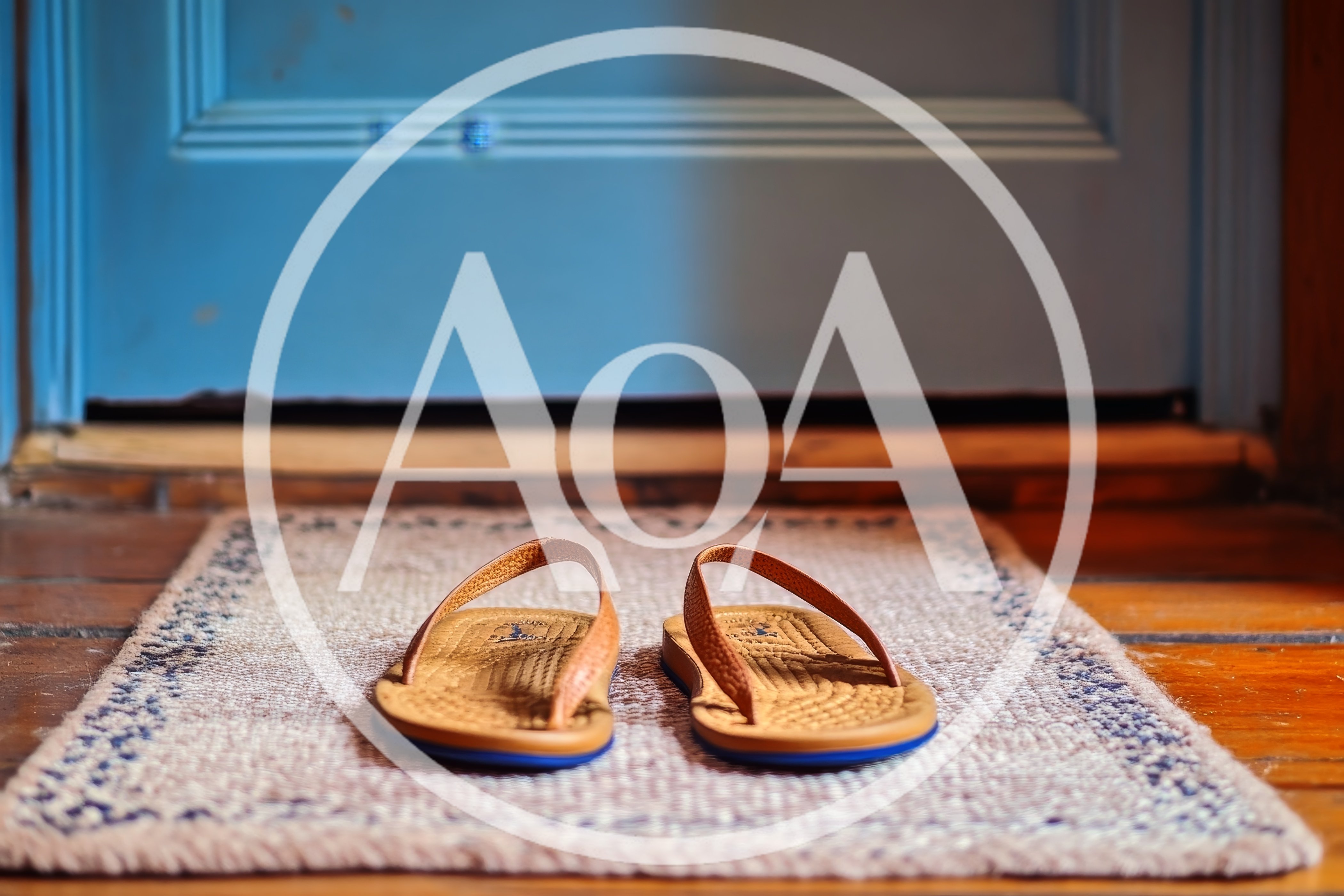Pair Of Leather Flip Flops On A Doormat