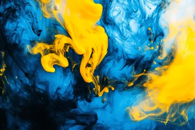 Yellow Ink Swirling In Blue Liquid