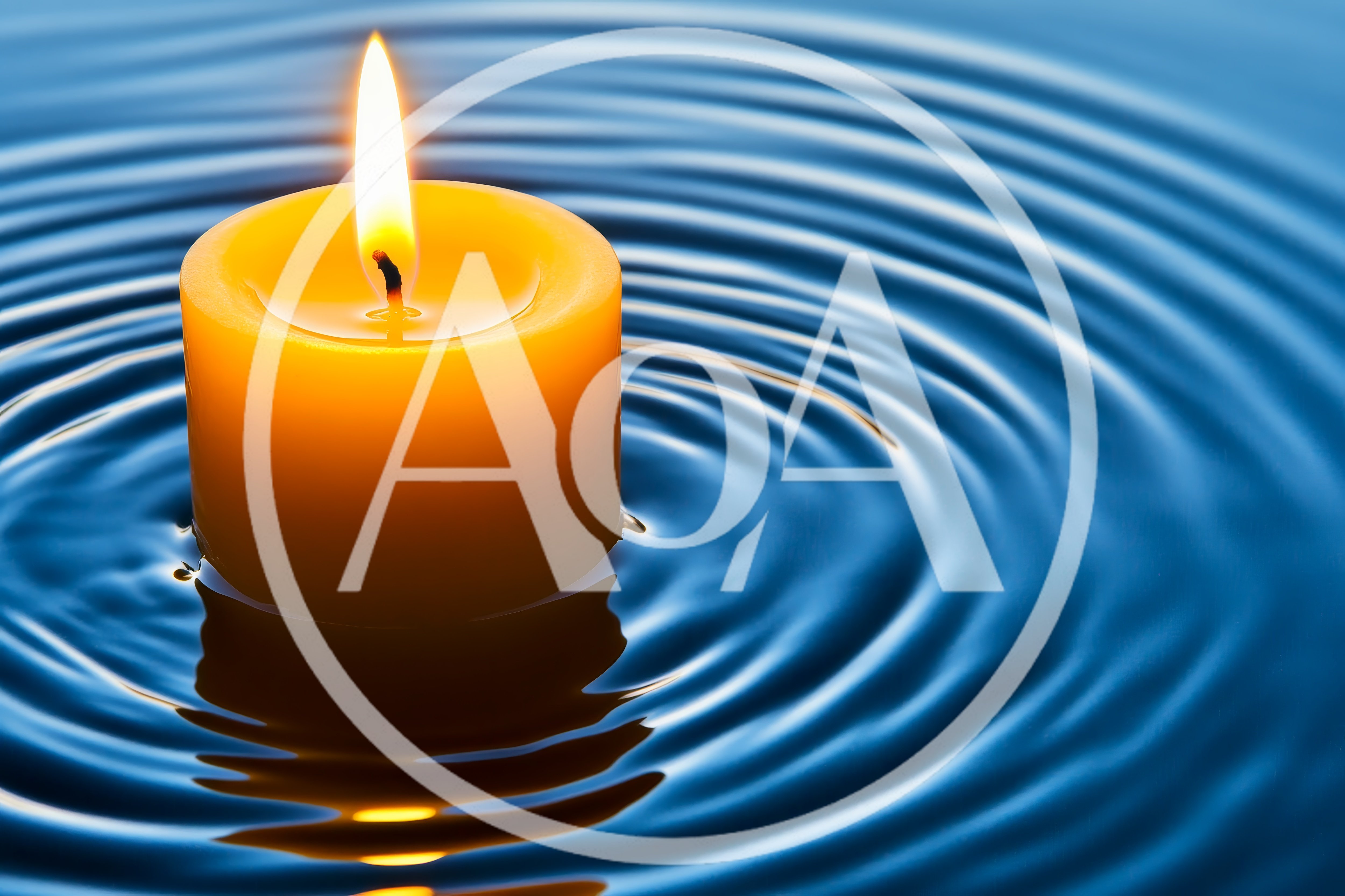 Yellow Candle Floating On Rippling Blue Water