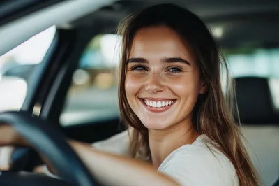 Happy Young Woman Driving A Car