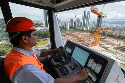 Crane Operator Controlling Construction Machinery In High Rise Cab