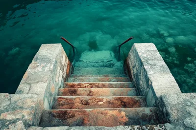 Stone Stairs Leading Into Clear Turquoise Water