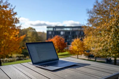 Laptop Computer Open On Outdoor Table In Autumn