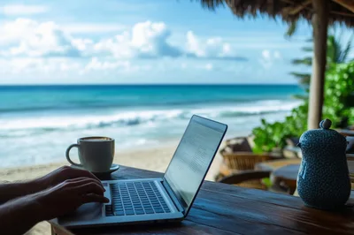 Person Working On Laptop At Beachside Cafe