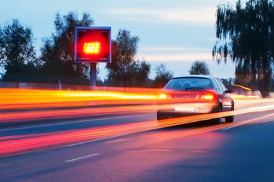 Car Driving On Highway At Dusk With Motion Blur