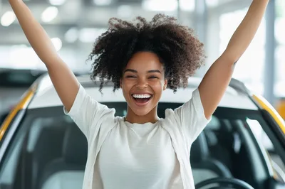 Excited Young Woman Celebrating In A Car Dealership