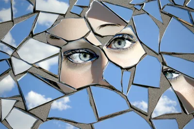 Close Up Of Human Eyes Reflected In Broken Mirror Shards