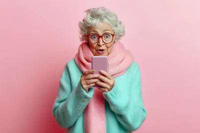 Surprised Elderly Woman Looking at Smartphone