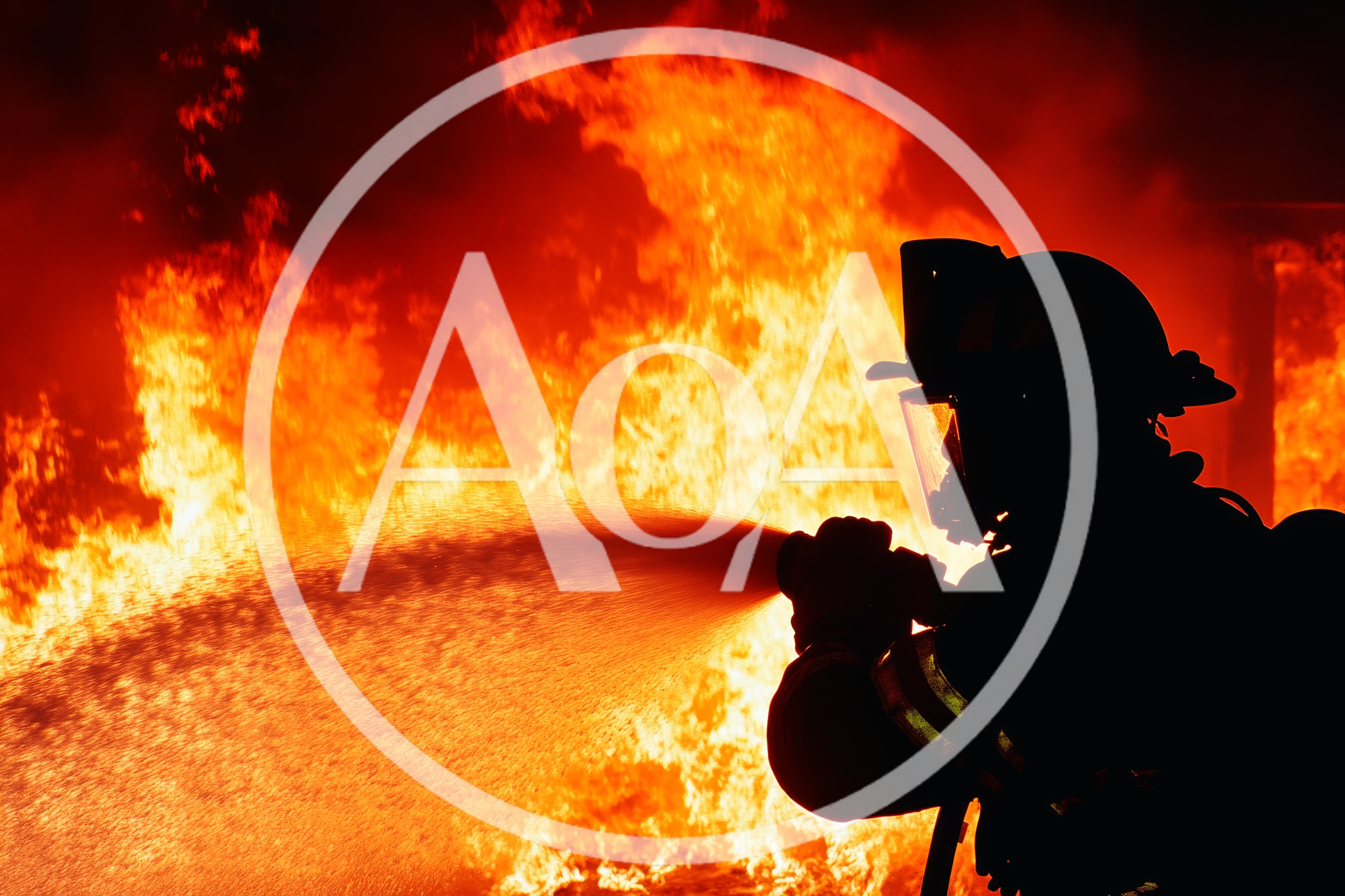 Firefighter Silhouetted Against Intense Raging Fire