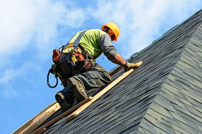 Roofer Installing Asphalt Shingles On A Residential Roof