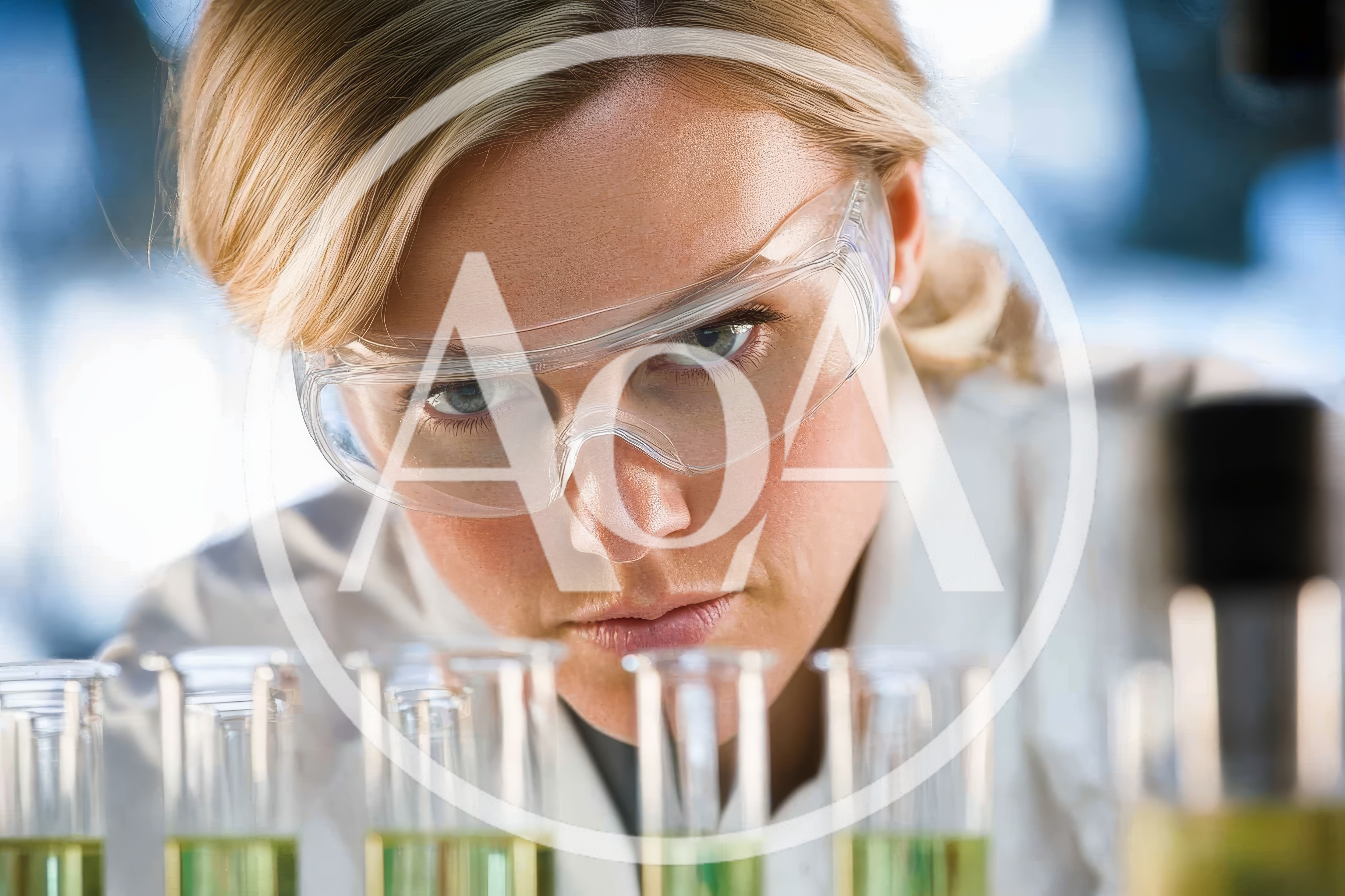 Female Scientist Examining Test Tubes In Laboratory