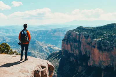 Hiker Standing On The Edge Of A Canyon