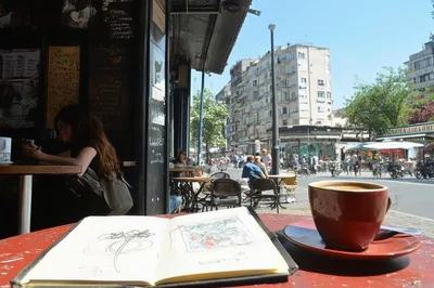 Sketchbook And Coffee Cup On A Cafe Table