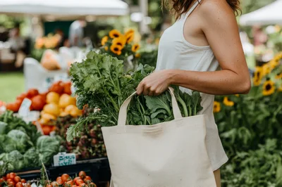 Woman Carrying Fresh Leafy Greens In Canvas Tote