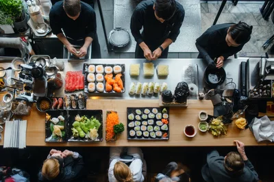 Chefs Preparing Sushi Rolls In A Professional Restaurant Kitchen