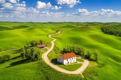 Aerial View of a Tuscan Farmhouse and Winding Road