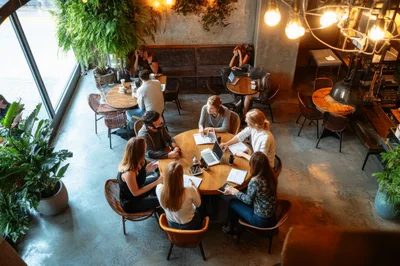 Diverse Business Team Collaborating During Meeting In Cafe