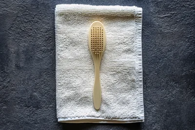 Wooden Bath Brush On White Towel