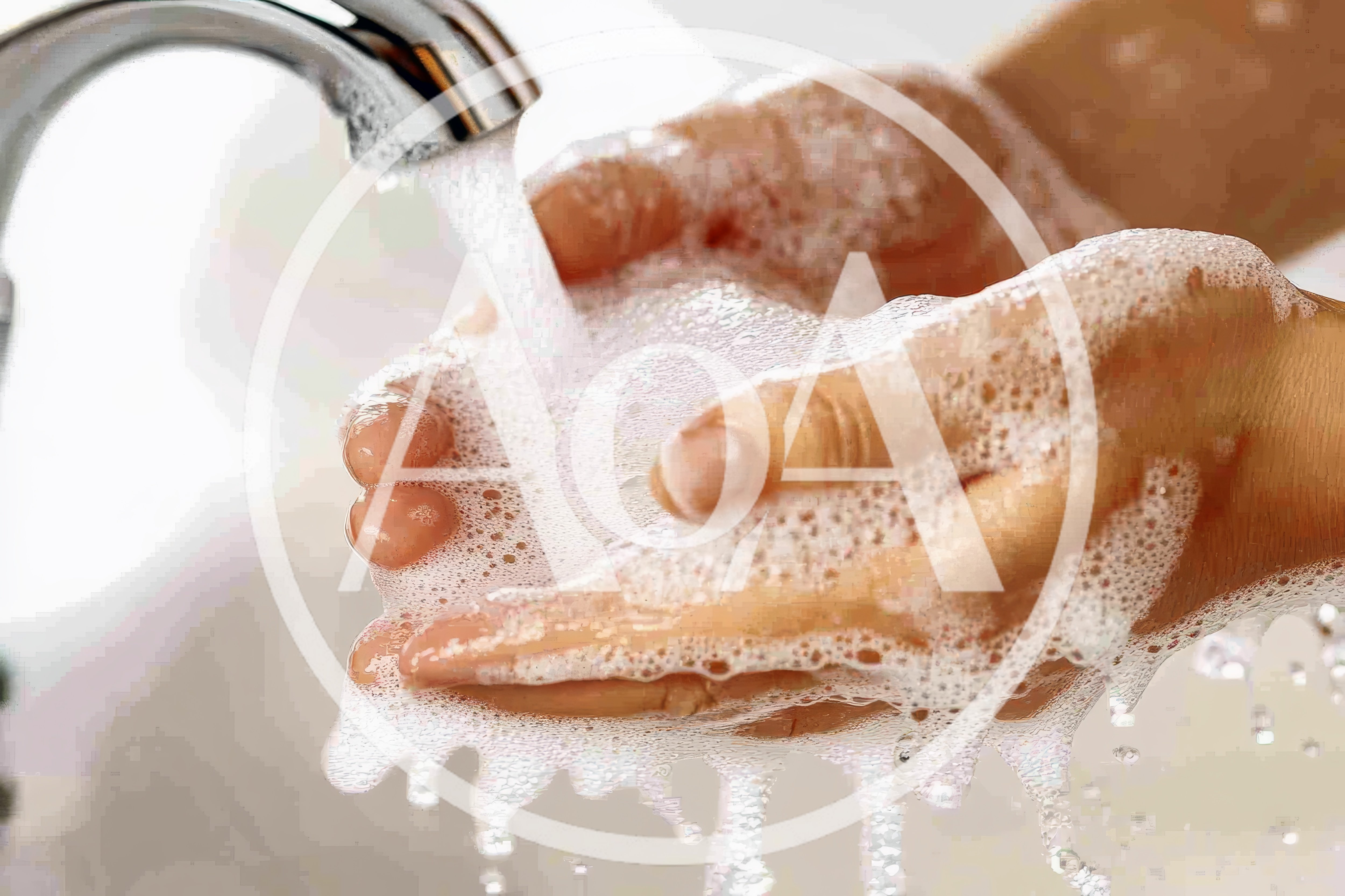 Person Washing Hands With Soap Under Running Water