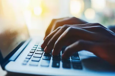 Close Up Of Person Typing On Laptop Keyboard