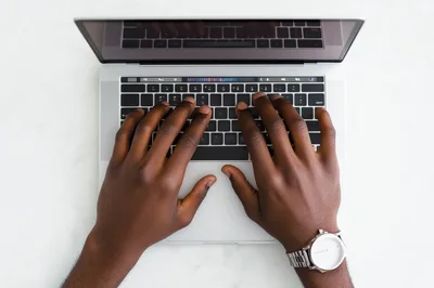 Top Down View Of Person Typing On Laptop
